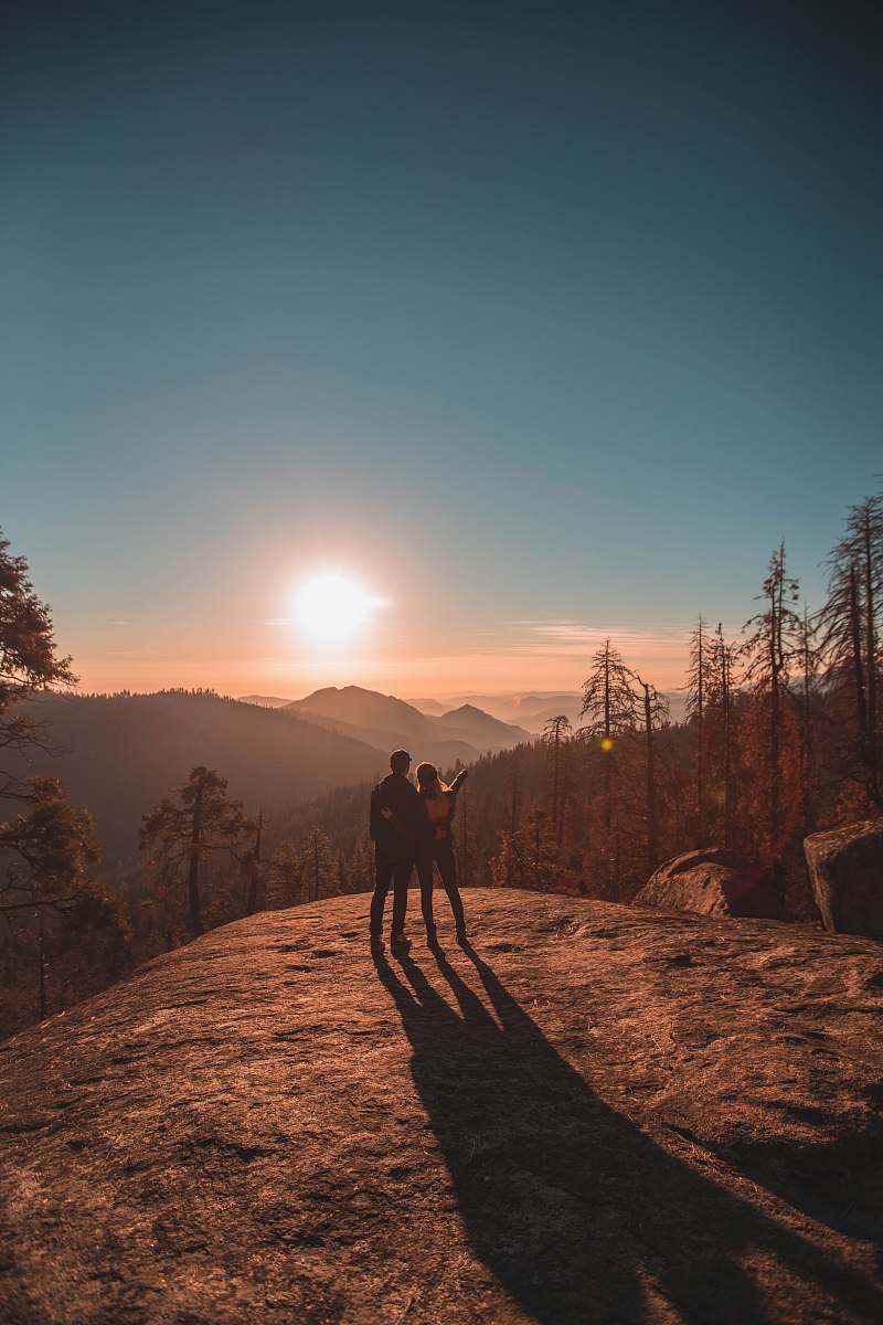 sequoia national park silhouette of man and woman on hill dirt road